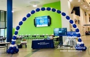 blue and white balloons forming a large arch.